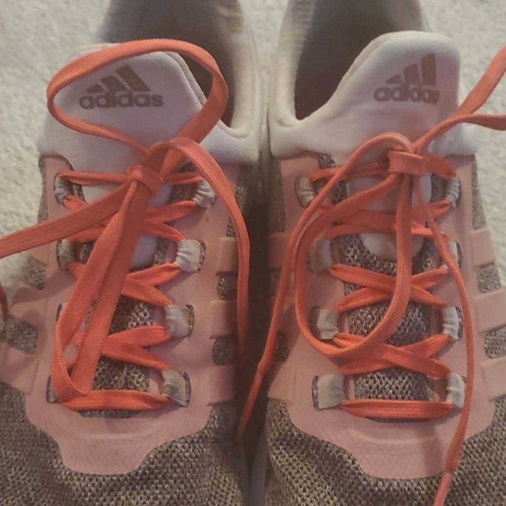 Adidas pink and white running shoes. Lots of life in then left fur lucky…